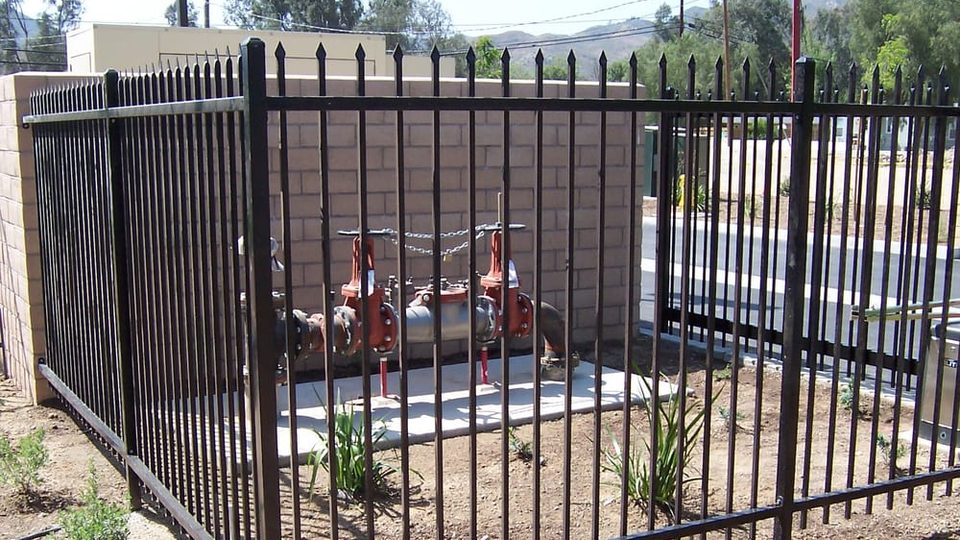 Tall non-combustible black iron fence, a Zone Zero approved material